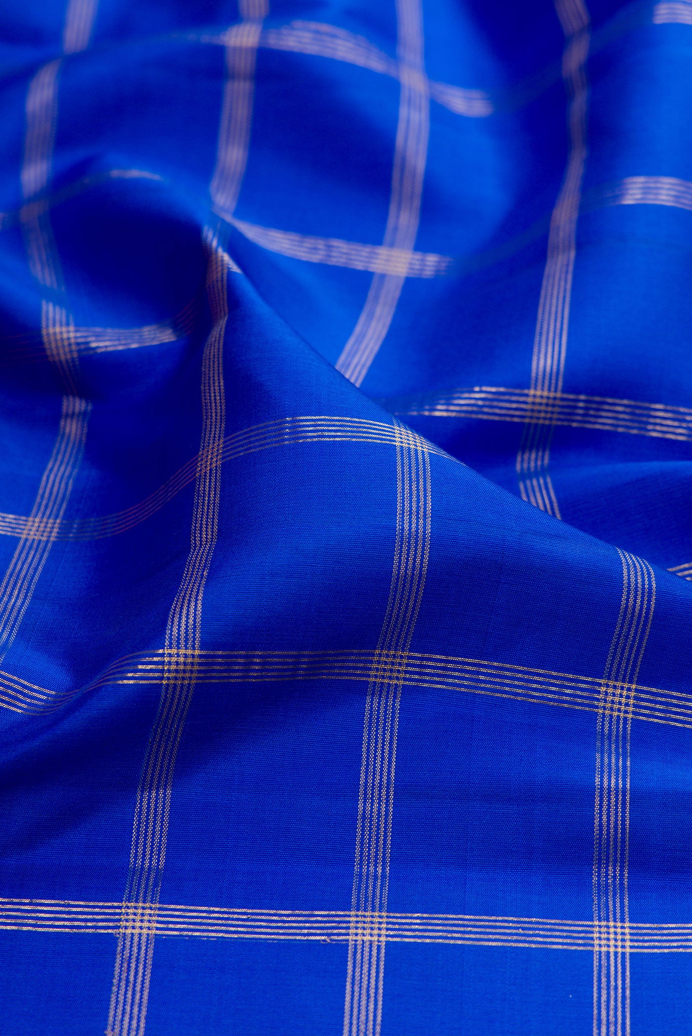 Close up of Pure Silk Pure Zari Royal Blue Kanjivaram Saree with Checked design on the body and Temple Border.  displaying folds