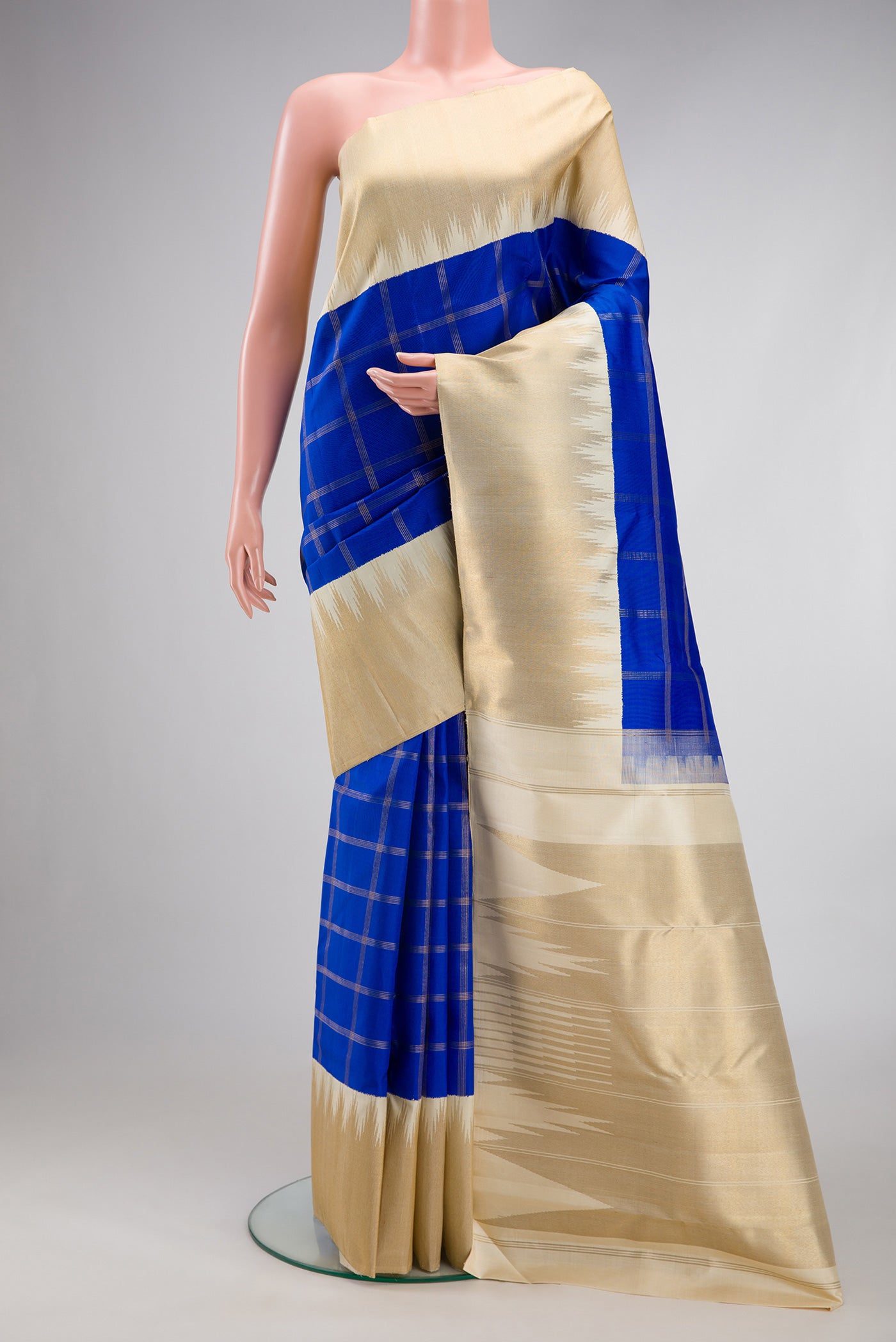 Pure Silk Pure Zari Royal Blue Kanjivaram Saree with Checked design on the body and Temple Border.  displayed on a mannequin