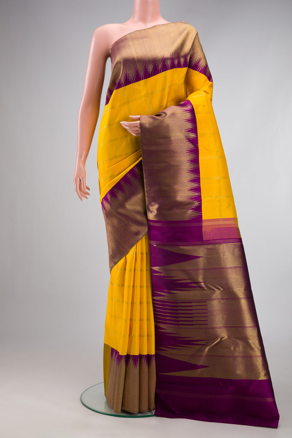 Pure Silk Pure Zari Yellow Kanjivaram Saree with Checked design on the body and Temple Border.  displayed on a mannequin