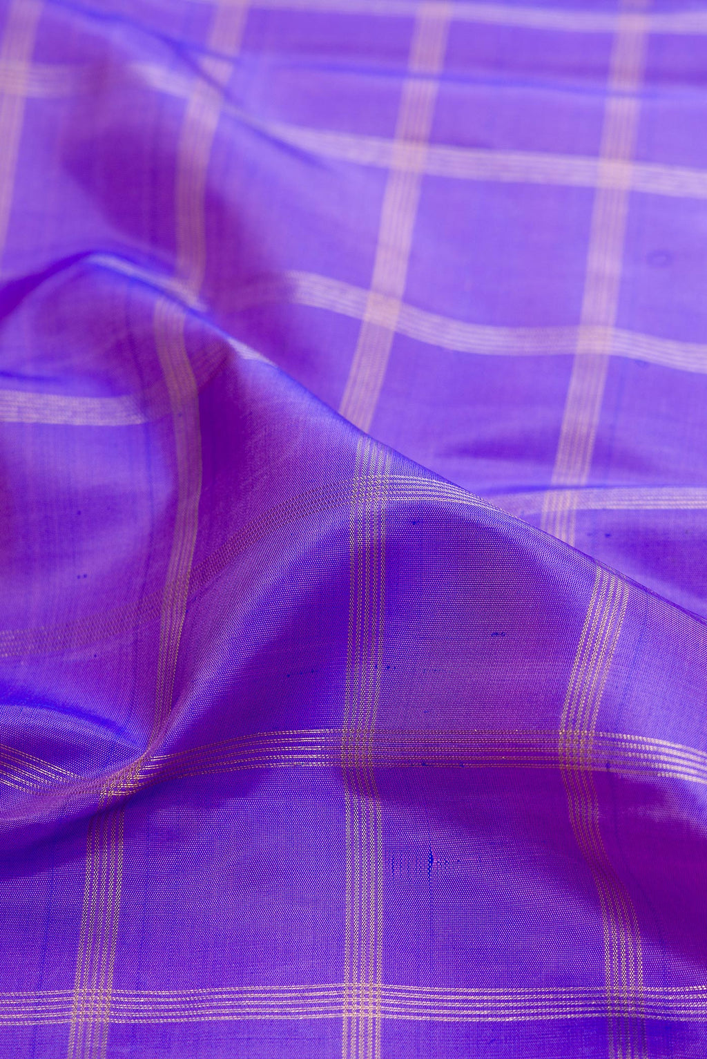 Close up of Pure Silk Pure Zari Lavender Kanjivaram Saree with Checked design on the body and Zari Border.  displaying folds