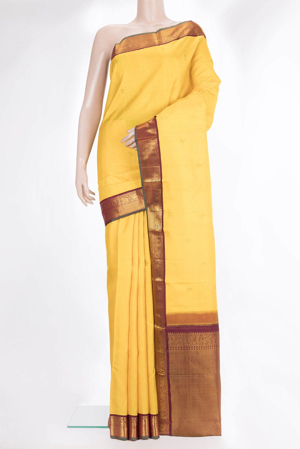 Pure Silk Yellow Kanjivaram Saree with Zari Butta on the body and Zari Border.  displayed on a mannequin
