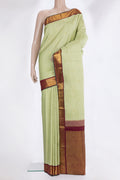 Pure Silk Pista Green Kanjivaram Saree with Zari Butta on the body and Zari Border.  displayed on a mannequin