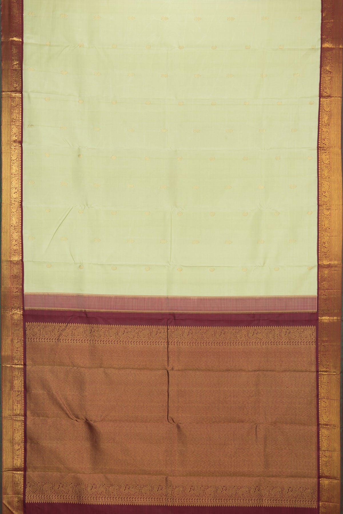 Flat view of Pure Silk Pista Green Kanjivaram Saree with Zari Butta on the body and Zari Border. 