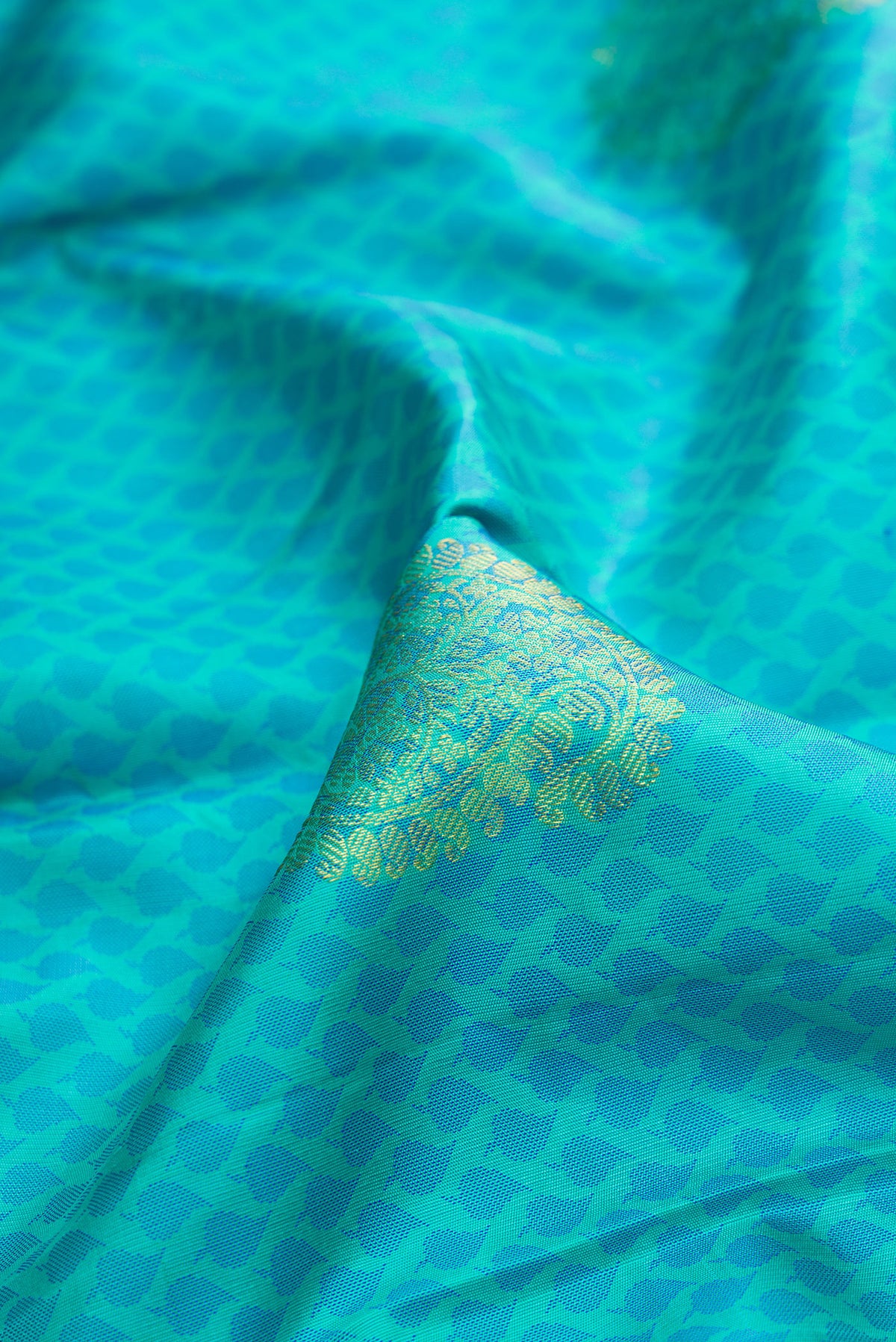 Close up of Pure Silk Sky Blue Kanchipuram Saree with Jacquard With Zari Butta on the body and Fancy Border.  displaying folds
