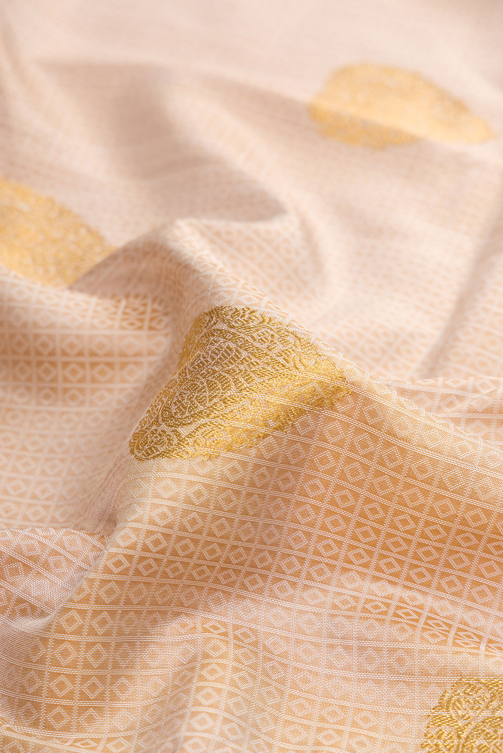 Close up of Pure Silk Beige Kanchipuram Saree with Jacquard With Zari Butta on the body and Without Border.  displaying folds
