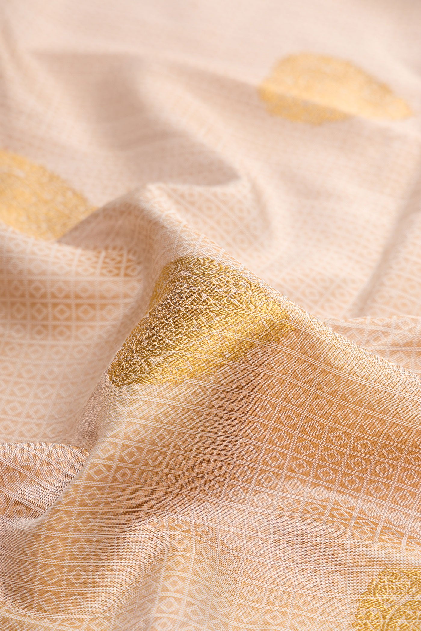 Close up of Pure Silk Beige Kanchipuram Saree with Jacquard With Zari Butta on the body and Without Border.  displaying folds