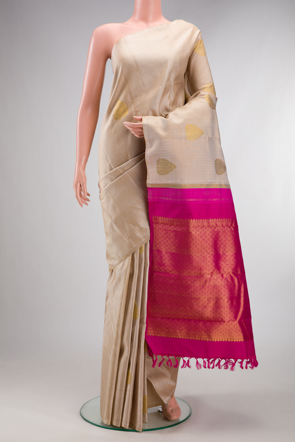 Pure Silk Beige Kanchipuram Saree with Jacquard With Zari Butta on the body and Without Border.  displayed on a mannequin