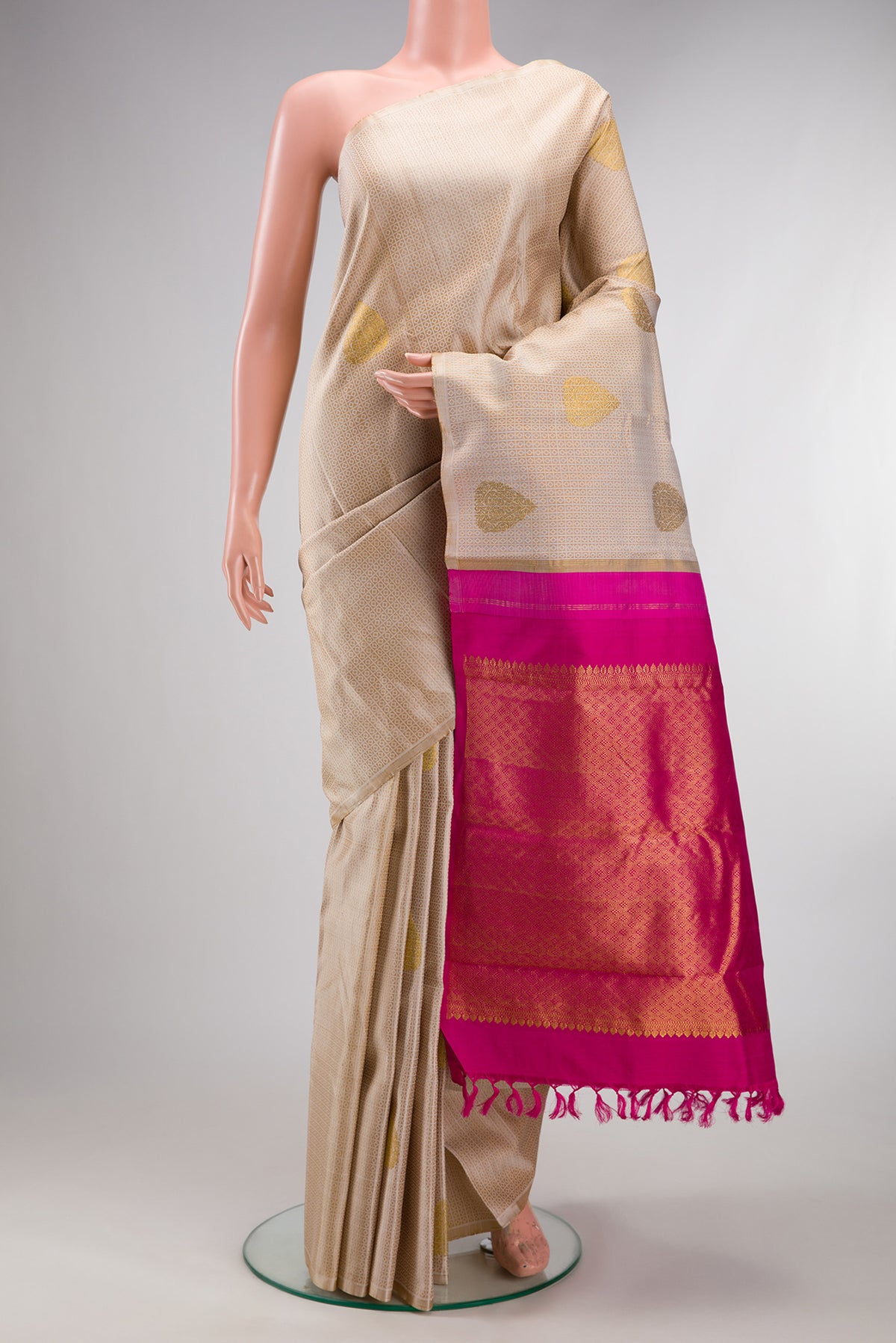 Pure Silk Beige Kanchipuram Saree with Jacquard With Zari Butta on the body and Without Border.  displayed on a mannequin