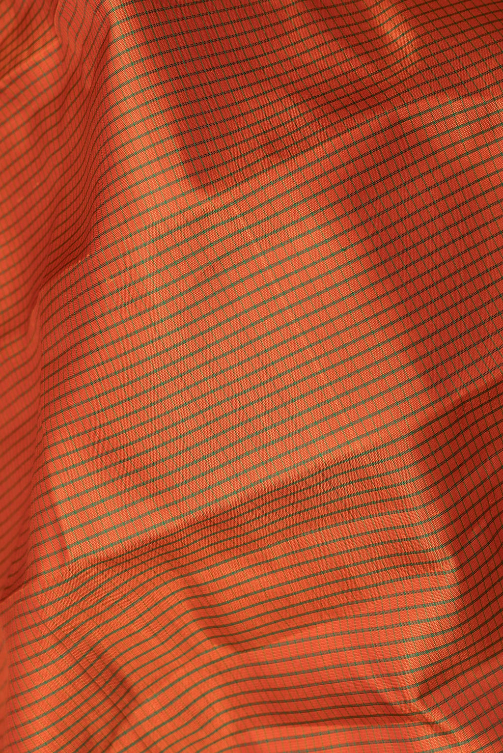 Close up of Pure Silk Orange Kanjivaram Saree with Checked design on the body and Fancy Border.  displaying folds