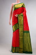 Pure Silk Orange Kanjivaram Saree with Zari Butta on the body and Zari Border.  displayed on a mannequin