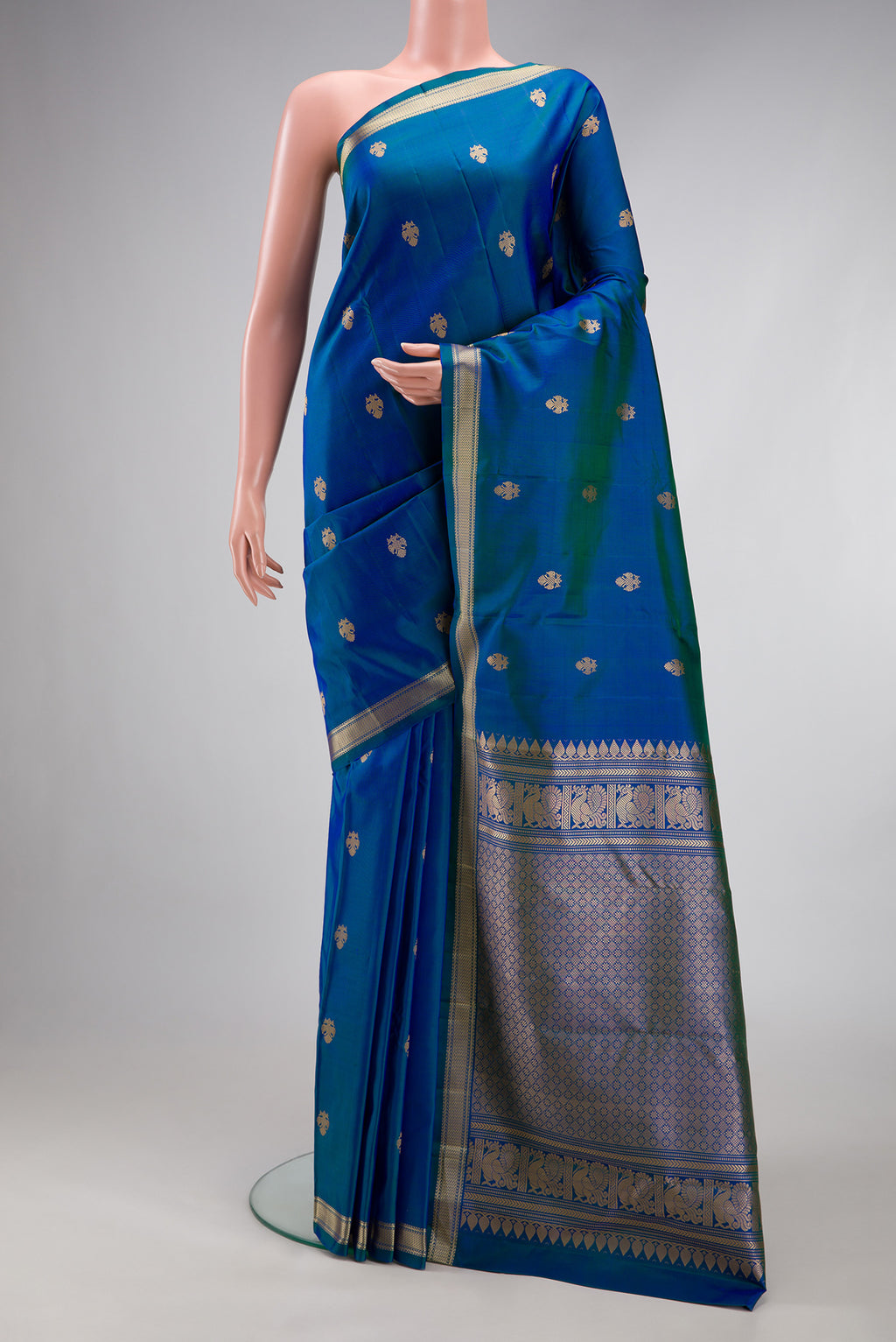 Peacock Blue Dual Tone Kanchipuram Silk Saree with Thread Butta on the body and Thread Border.  displayed on a mannequin