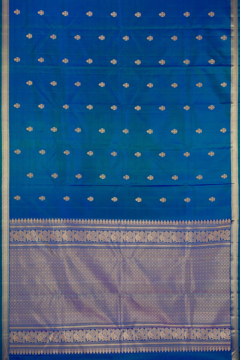 Flat view of Peacock Blue Dual Tone Kanchipuram Silk Saree with Thread Butta on the body and Thread Border. 
