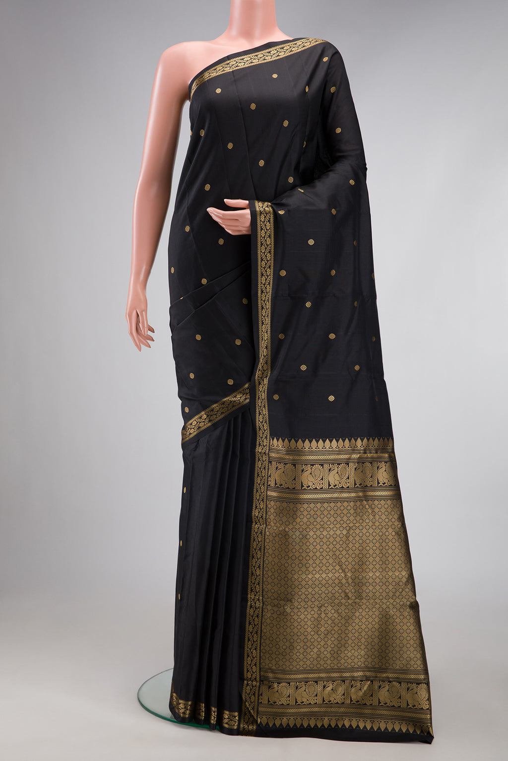 Black Kanchipuram Silk Saree with Thread Butta on the body and Thread Border.  displayed on a mannequin