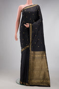 Black Kanchipuram Silk Saree with Thread Butta on the body and Thread Border.  displayed on a mannequin