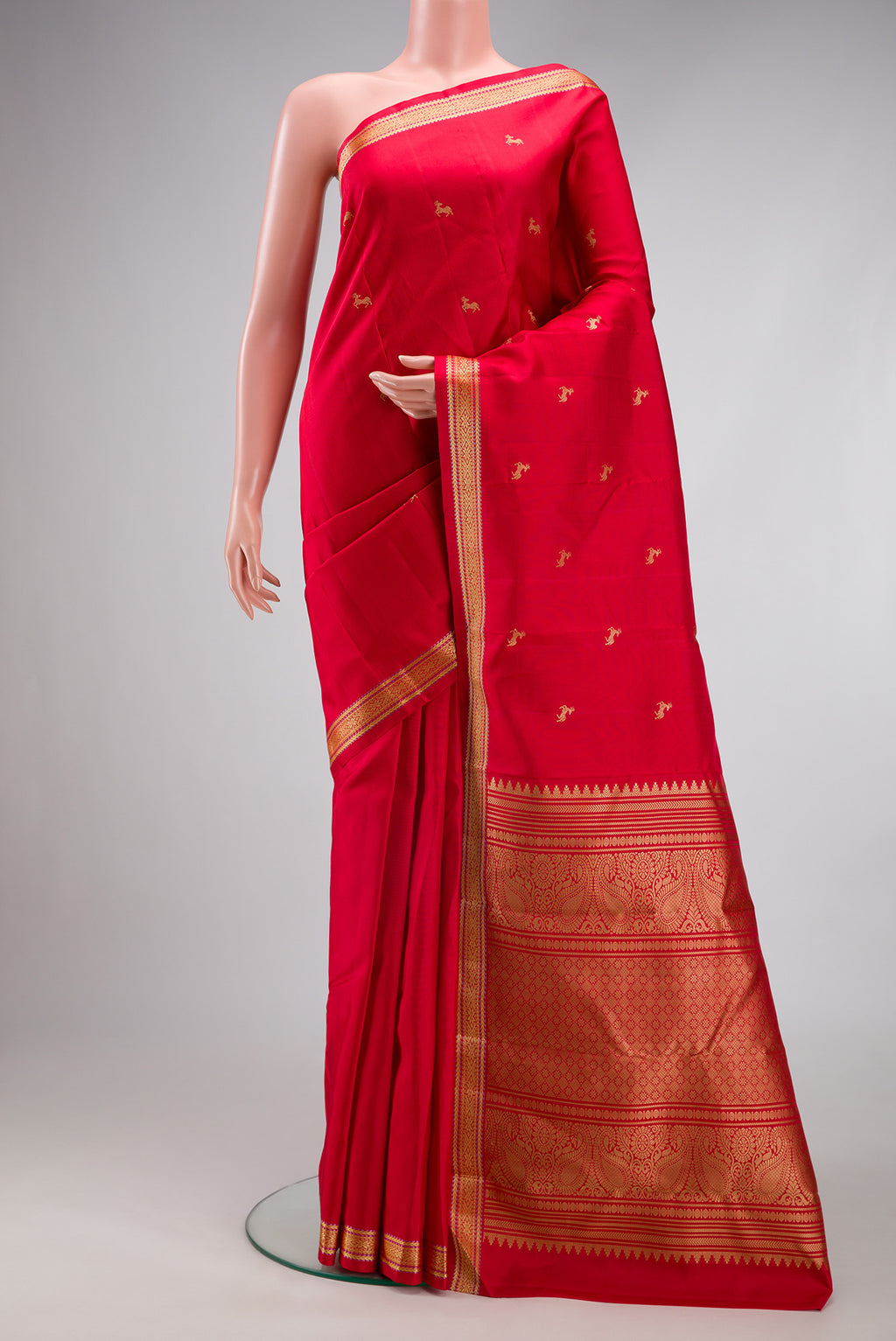 Red Kanchipuram Silk Saree with Thread Butta on the body and Thread Border.  displayed on a mannequin