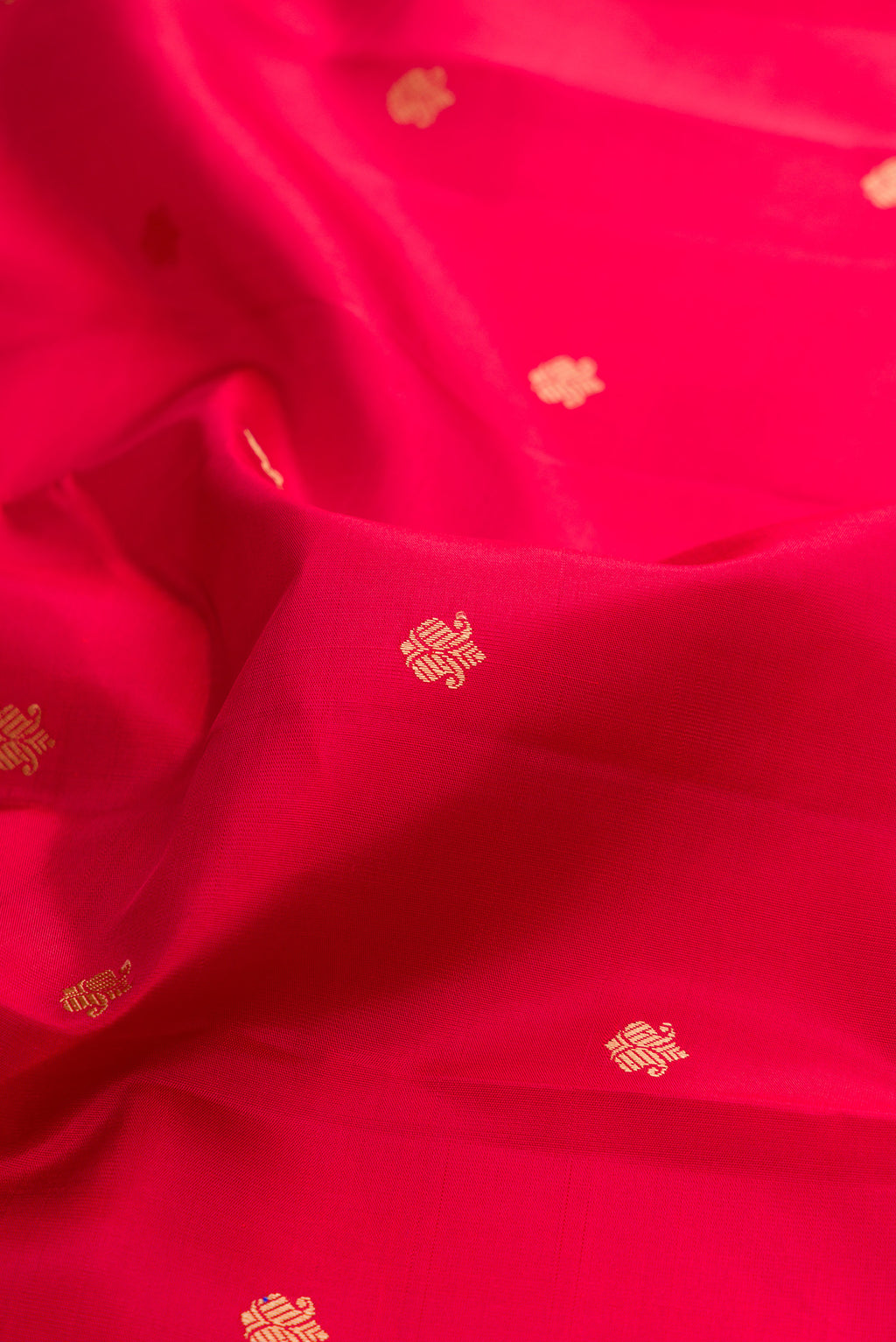 Close up of Red Kanchipuram Silk Saree with Thread Butta on the body and Thread Border.  displaying folds