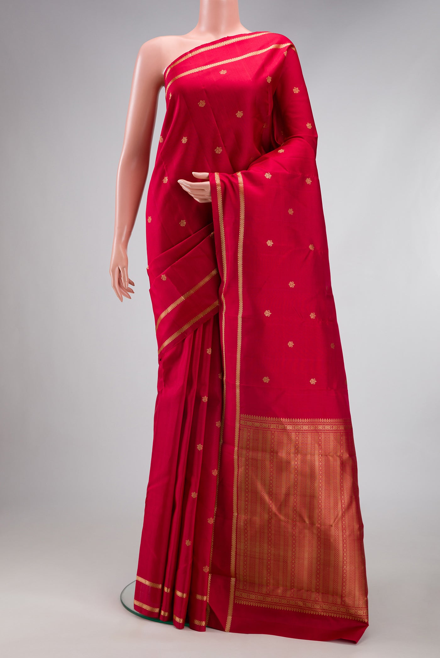 Red Kanchipuram Silk Saree with Thread Butta on the body and Thread Border.  displayed on a mannequin