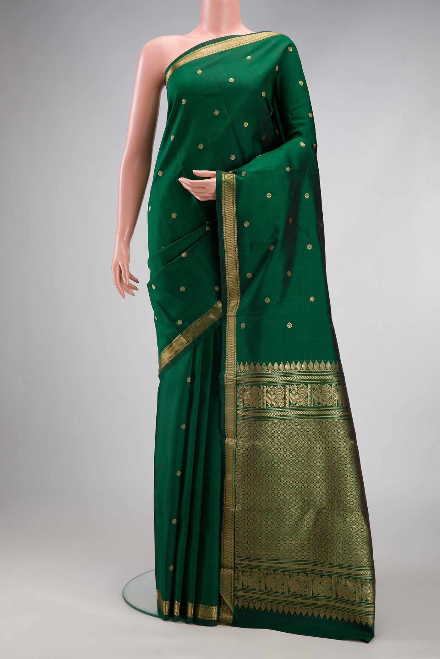 Bottle Green Kanchipuram Silk Saree with Thread Butta on the body and Thread Border.  displayed on a mannequin