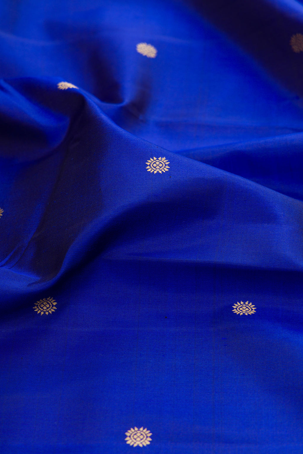 Close up of Royal Blue Kanchipuram Silk Saree with Thread Butta on the body and Thread Border.  displaying folds