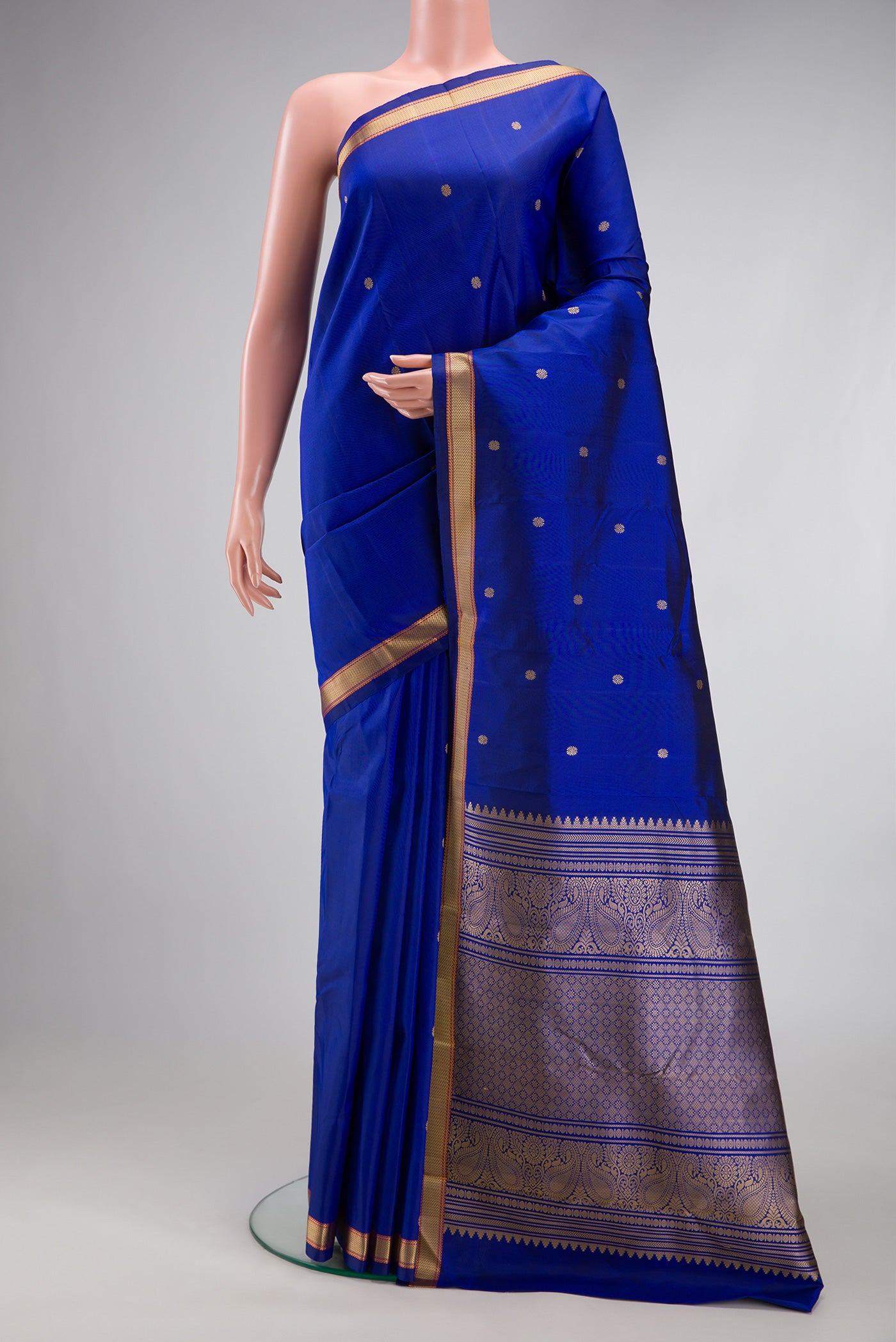 Royal Blue Kanchipuram Silk Saree with Thread Butta on the body and Thread Border.  displayed on a mannequin