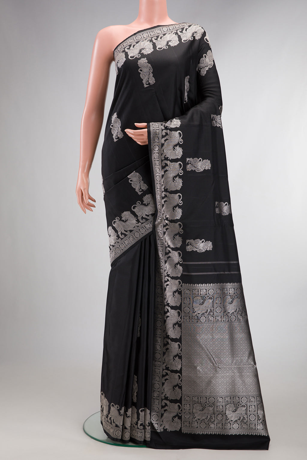 Pure Silk Black Dual Tone Kanjivaram Saree with Thread Butta on the body and Fancy Border.  displayed on a mannequin