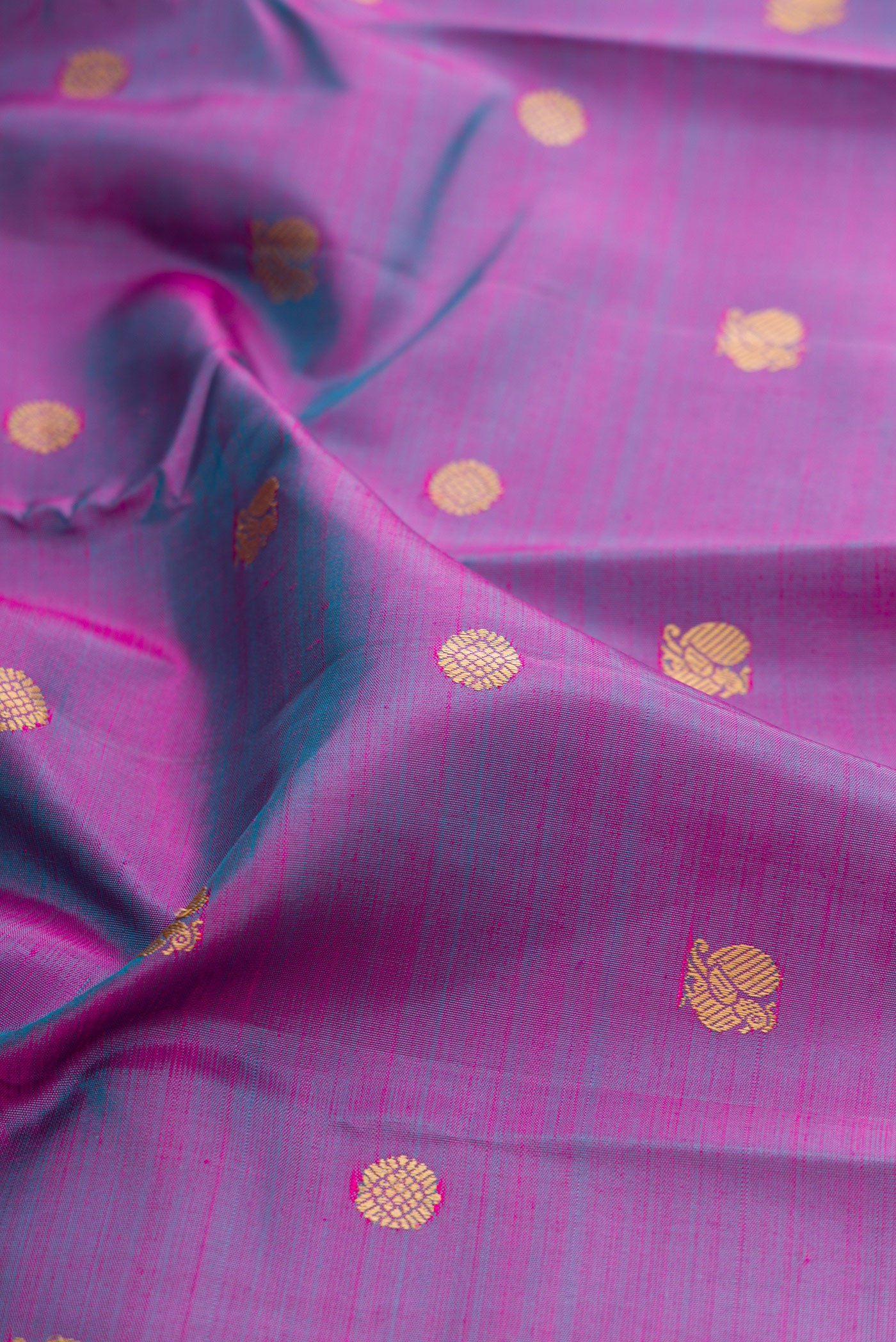 Close up of Lavender Dual Tone Kanjivaram Silk Saree with Thread Butta on the body and Thread Border.  displaying folds