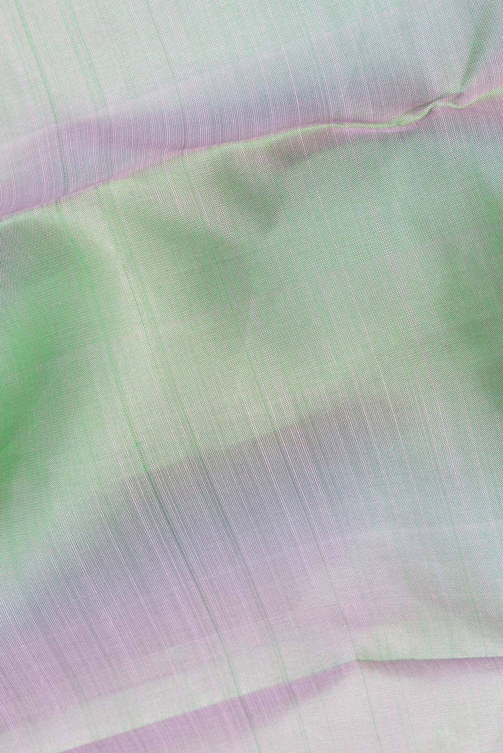 Close up of Pure Silk Pista Green Dual Tone Kanjivaram Saree with Plain Body and Zari Border.  displaying folds