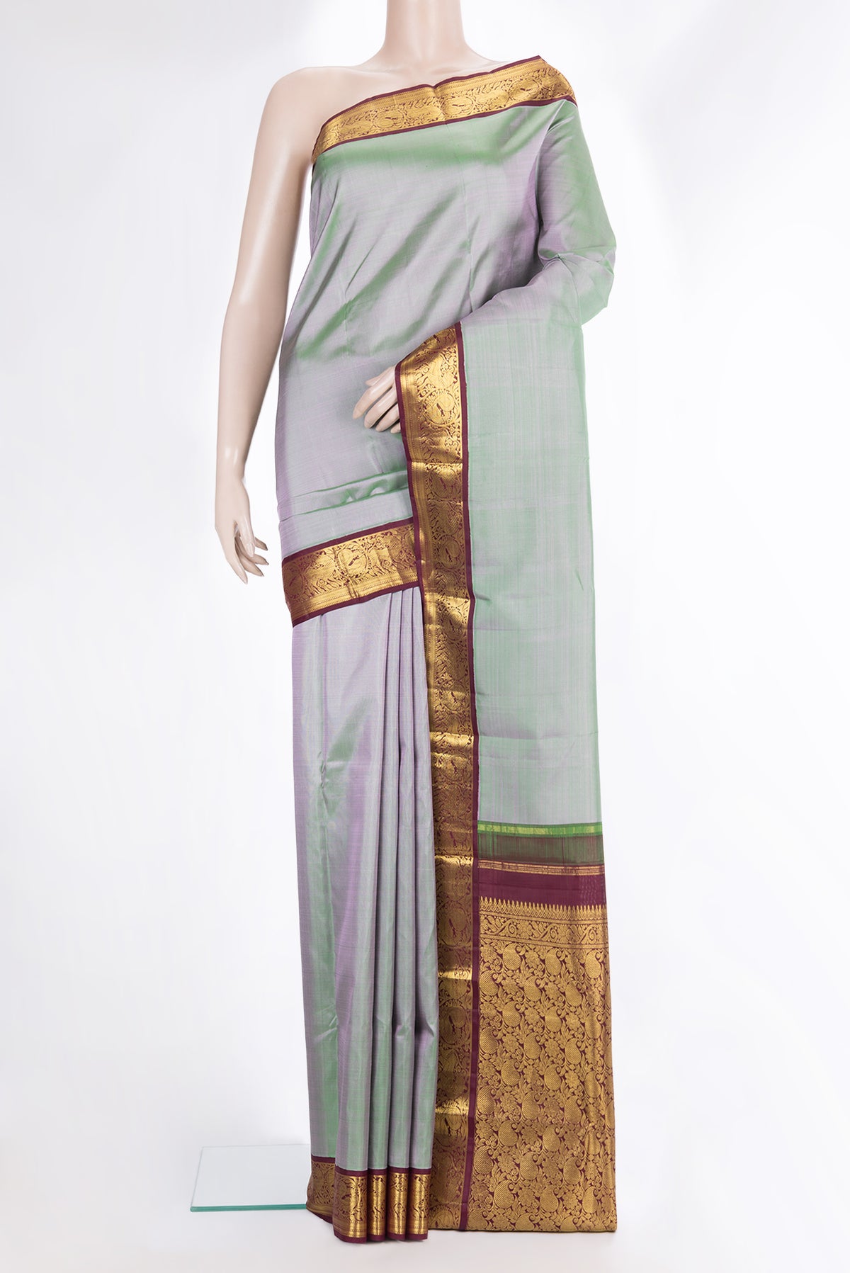 Pure Silk Pista Green Dual Tone Kanjivaram Saree with Plain Body and Zari Border.  displayed on a mannequin