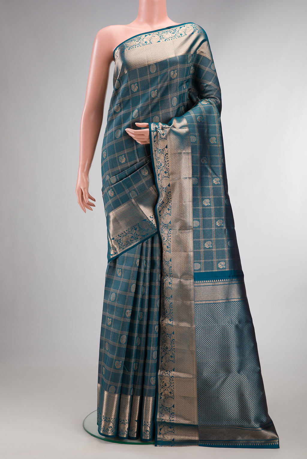 Pure Silk Teal Dual Tone Kanchipuram Saree with Zari Brocade on the body and Zari Border.  displayed on a mannequin