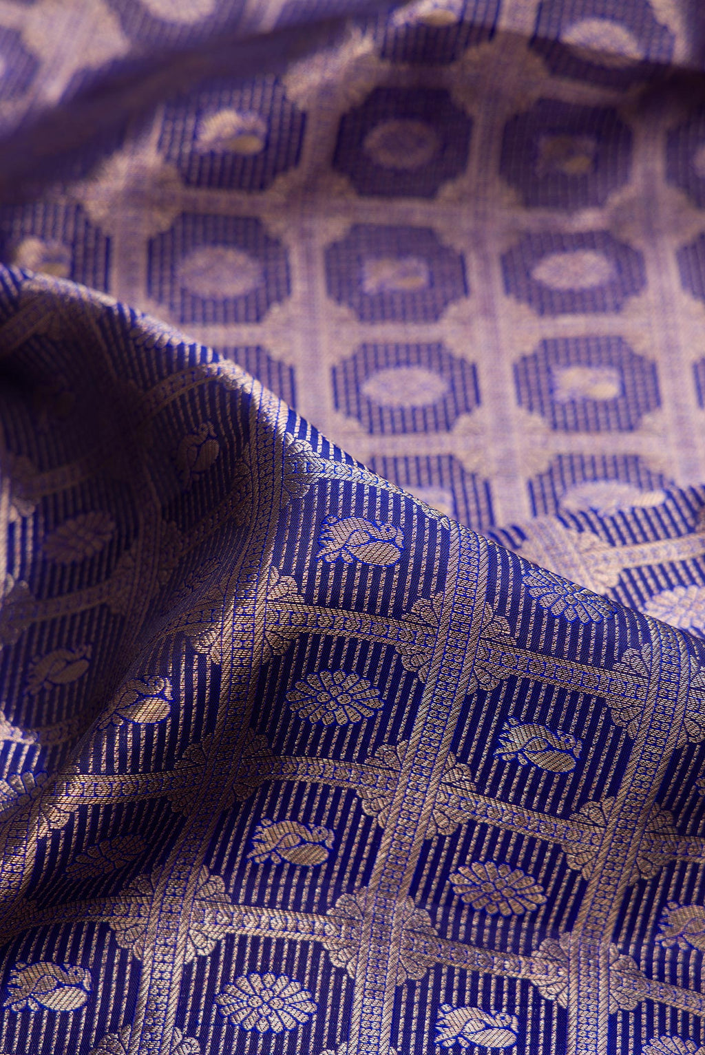 Close up of Pure Silk Dark Blue Kanchipuram Saree with Zari Brocade on the body and Zari Border.  displaying folds