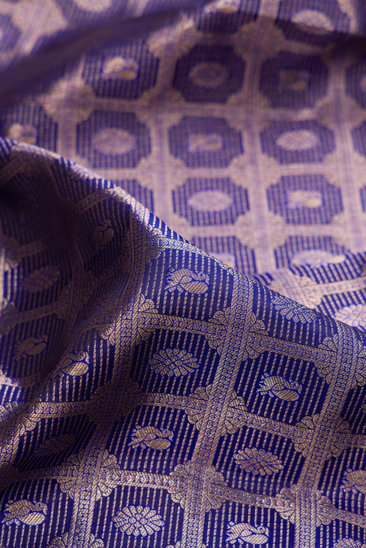 Close up of Pure Silk Dark Blue Kanchipuram Saree with Zari Brocade on the body and Zari Border.  displaying folds