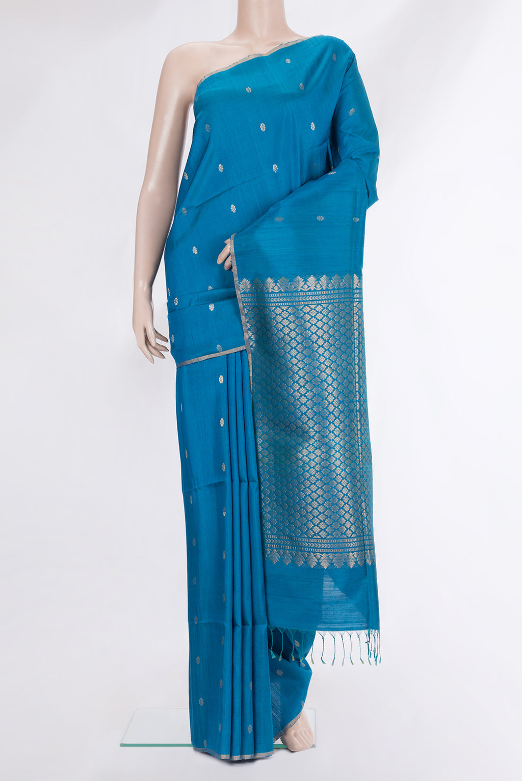 Light Blue Raw Saree with Zari Butta on the body and Zari Border.  displayed on a mannequin