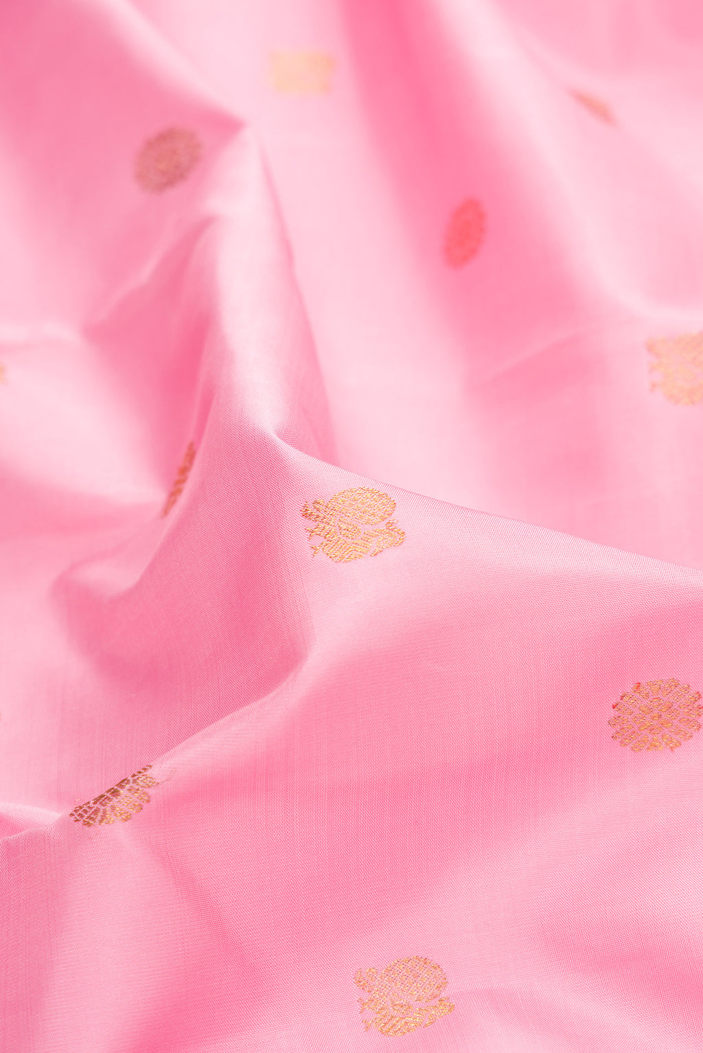 Close up of Pure Silk Pure Zari Pink Dual Tone Kanchipuram Saree with Zari Butta on the body and Zari Border.  displaying folds