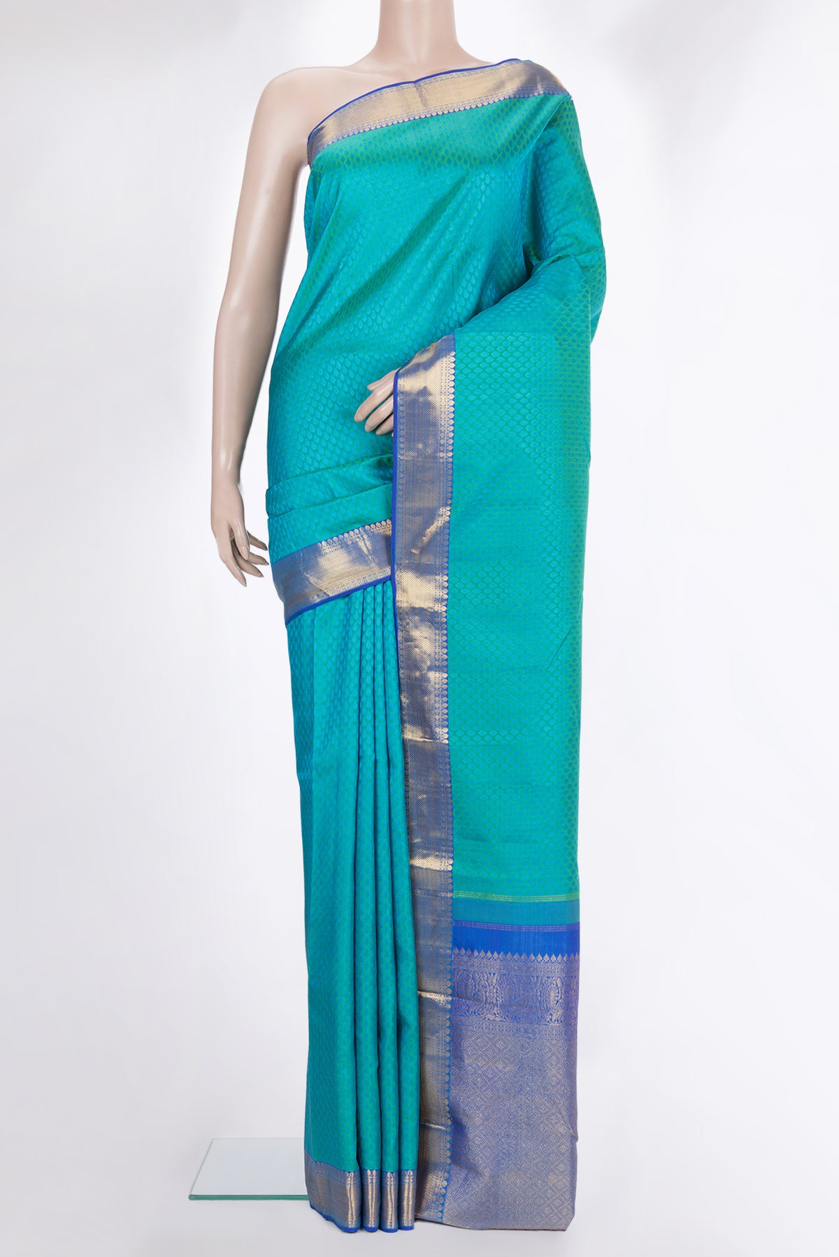 Pure Silk Sea Green Kanchipuram Saree with Jacquard design on the body and Zari Border.  displayed on a mannequin