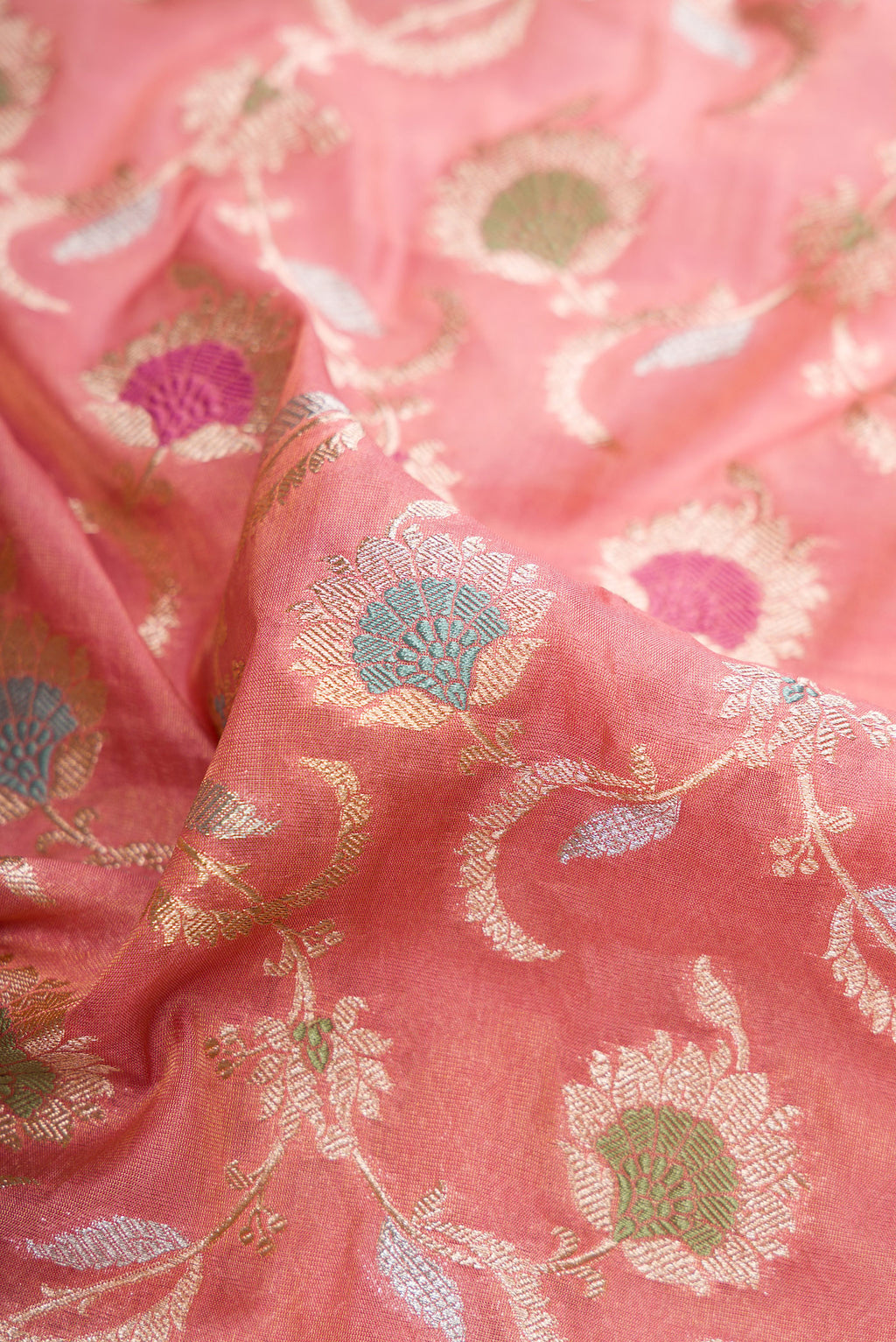 Close up of Pink Dual Tone Banarasi Silk Saree with Zari Brocade on the body and Fancy Border.  displaying folds