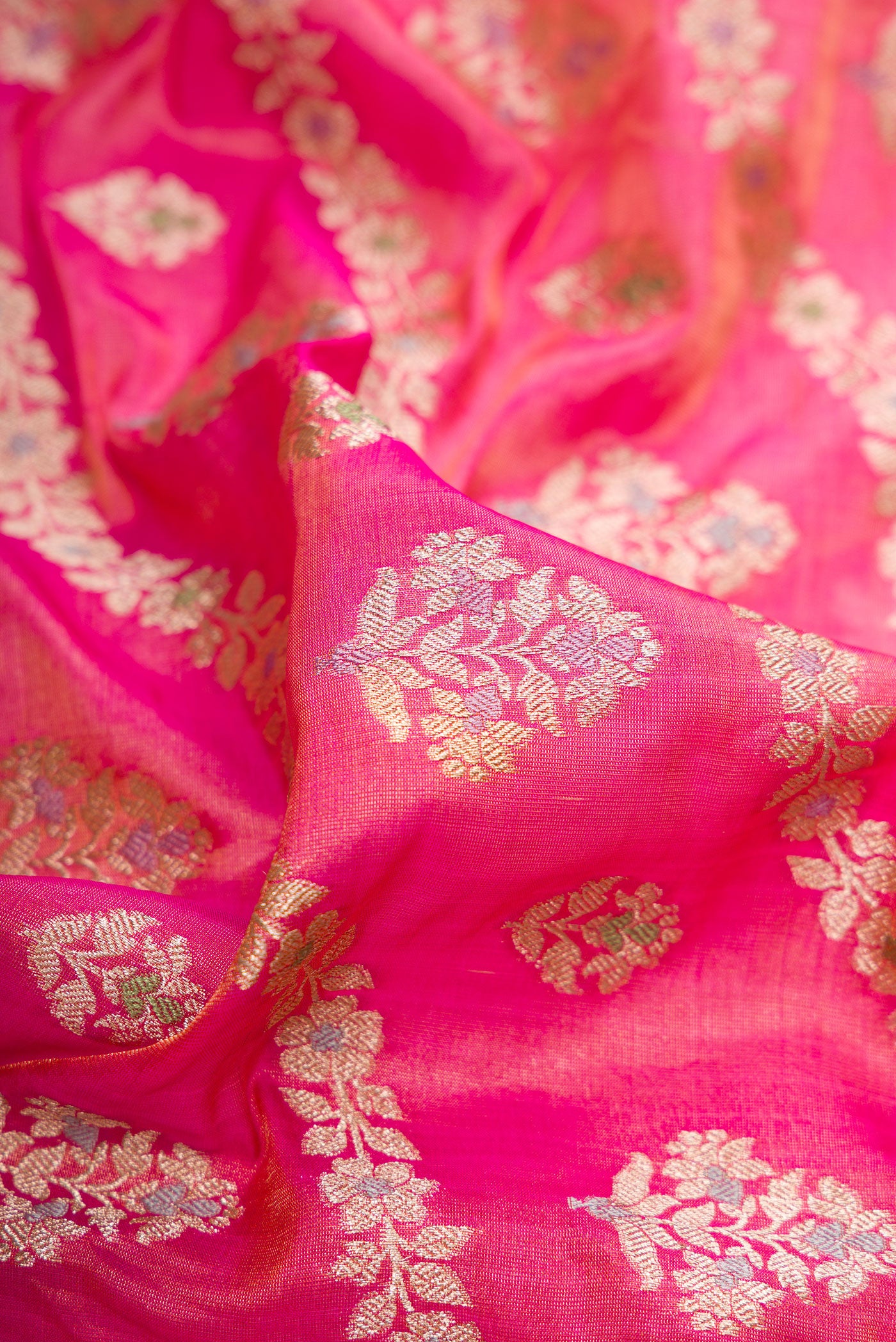 Close up of Pink Dual Tone Banarasi Silk Saree with Zari Brocade on the body and Fancy Border.  displaying folds