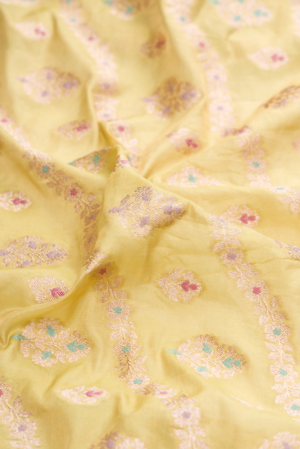 Close up of Light Green Dual Tone Banarasi Silk Saree with Zari Brocade on the body and Zari Border.  displaying folds