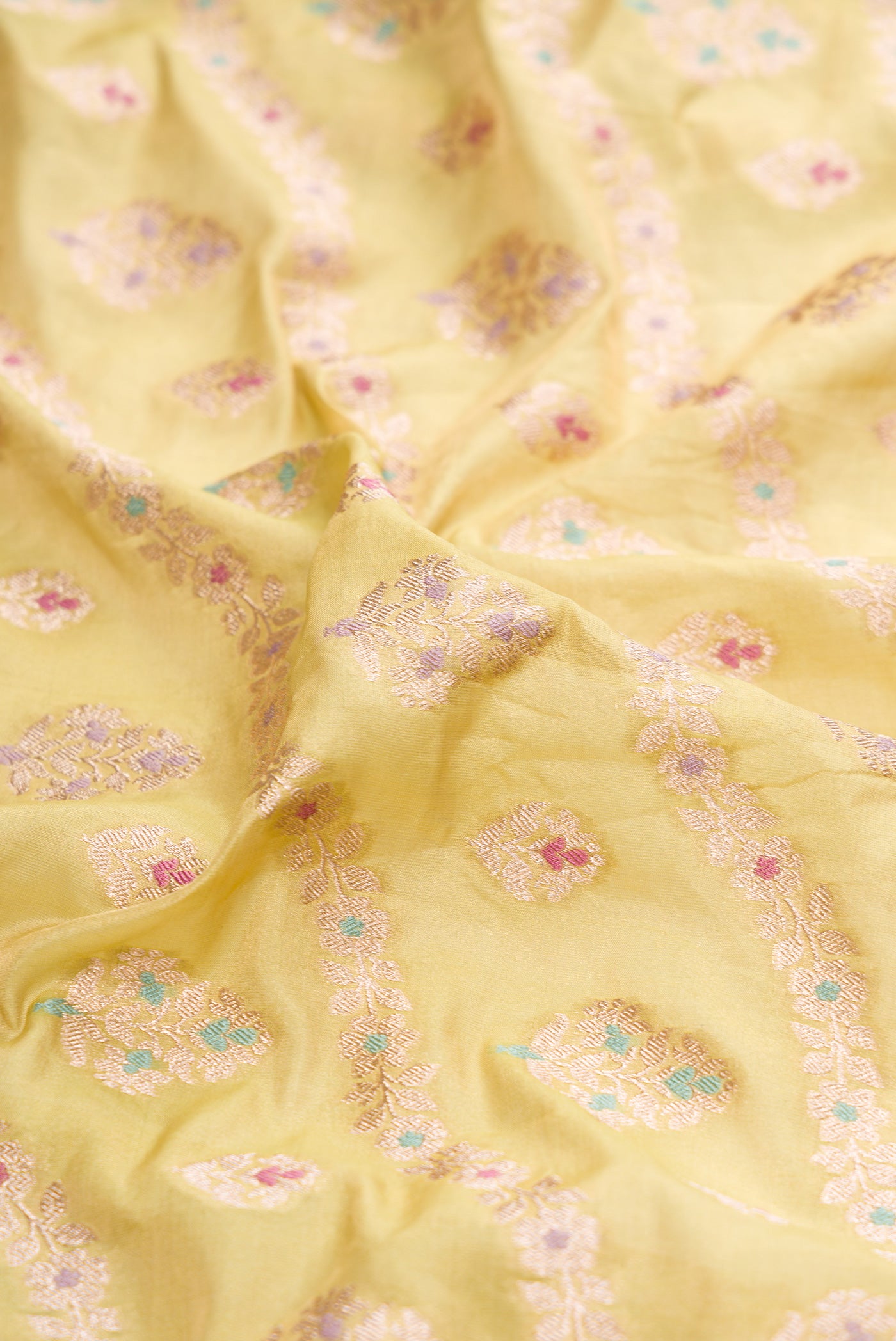 Close up of Light Green Dual Tone Banarasi Silk Saree with Zari Brocade on the body and Zari Border.  displaying folds
