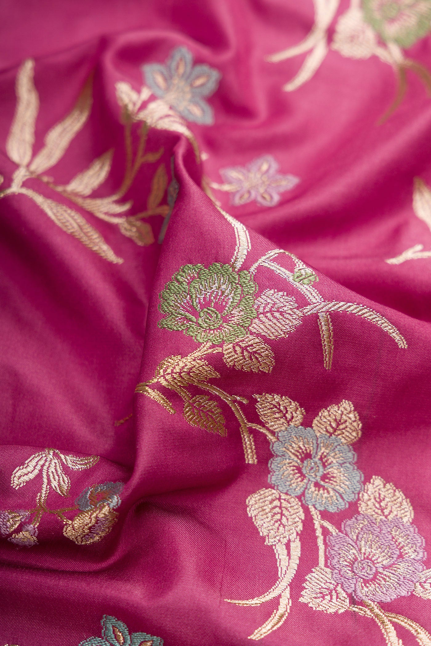 Close up of Light Magenta Banarasi Silk Saree with Zari Brocade on the body and Fancy Border.  displaying folds