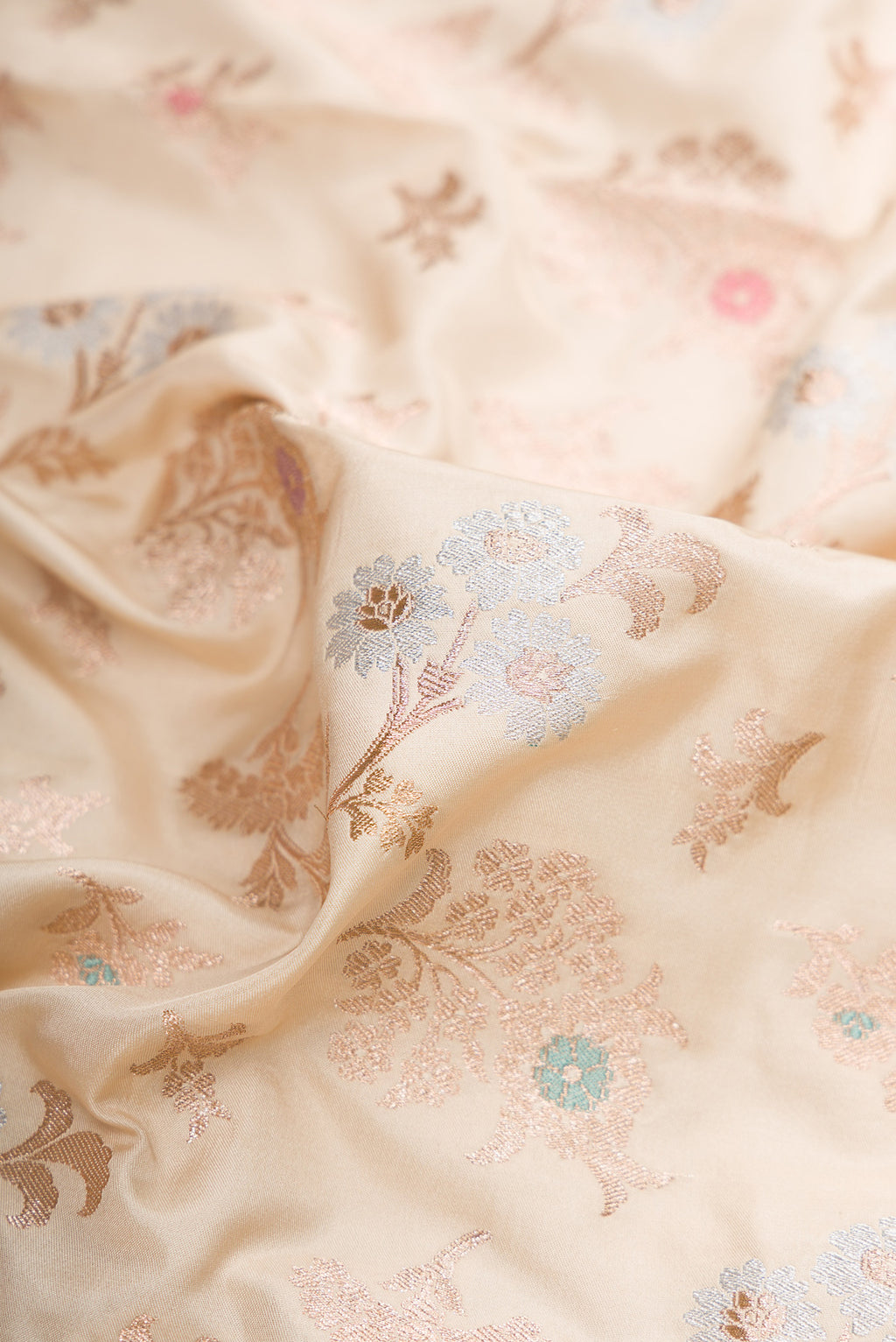Close up of Beige Dual Tone Banarasi Silk Saree with Zari Brocade on the body and Fancy Border.  displaying folds