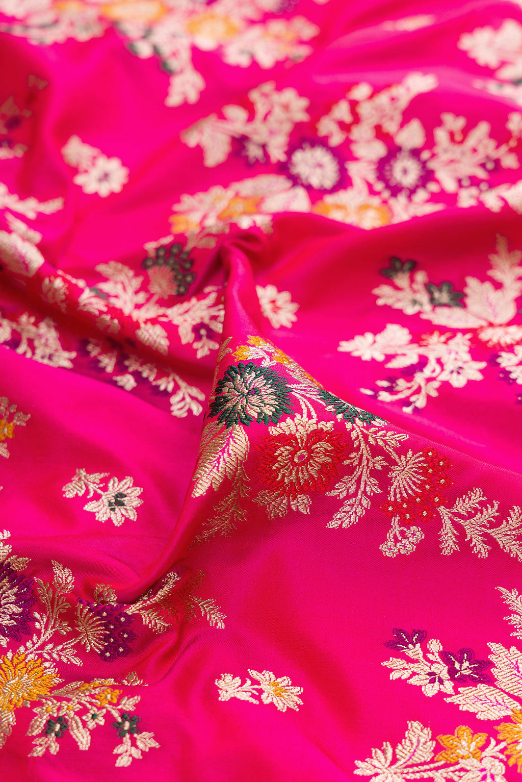 Close up of Dark Pink Banarasi Silk Saree with Zari Brocade on the body and Zari Border.  displaying folds