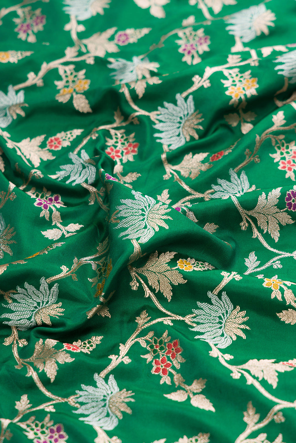 Close up of Green Banarasi Silk Saree with Zari Brocade on the body and Zari Border.  displaying folds