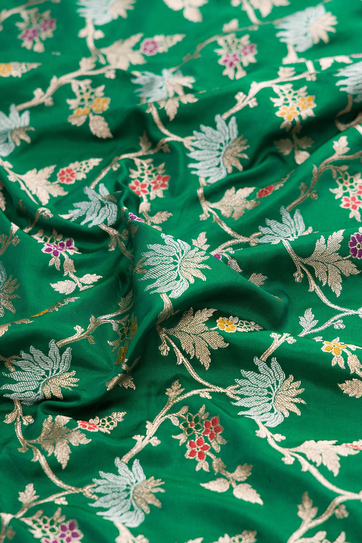 Close up of Green Banarasi Silk Saree with Zari Brocade on the body and Zari Border.  displaying folds