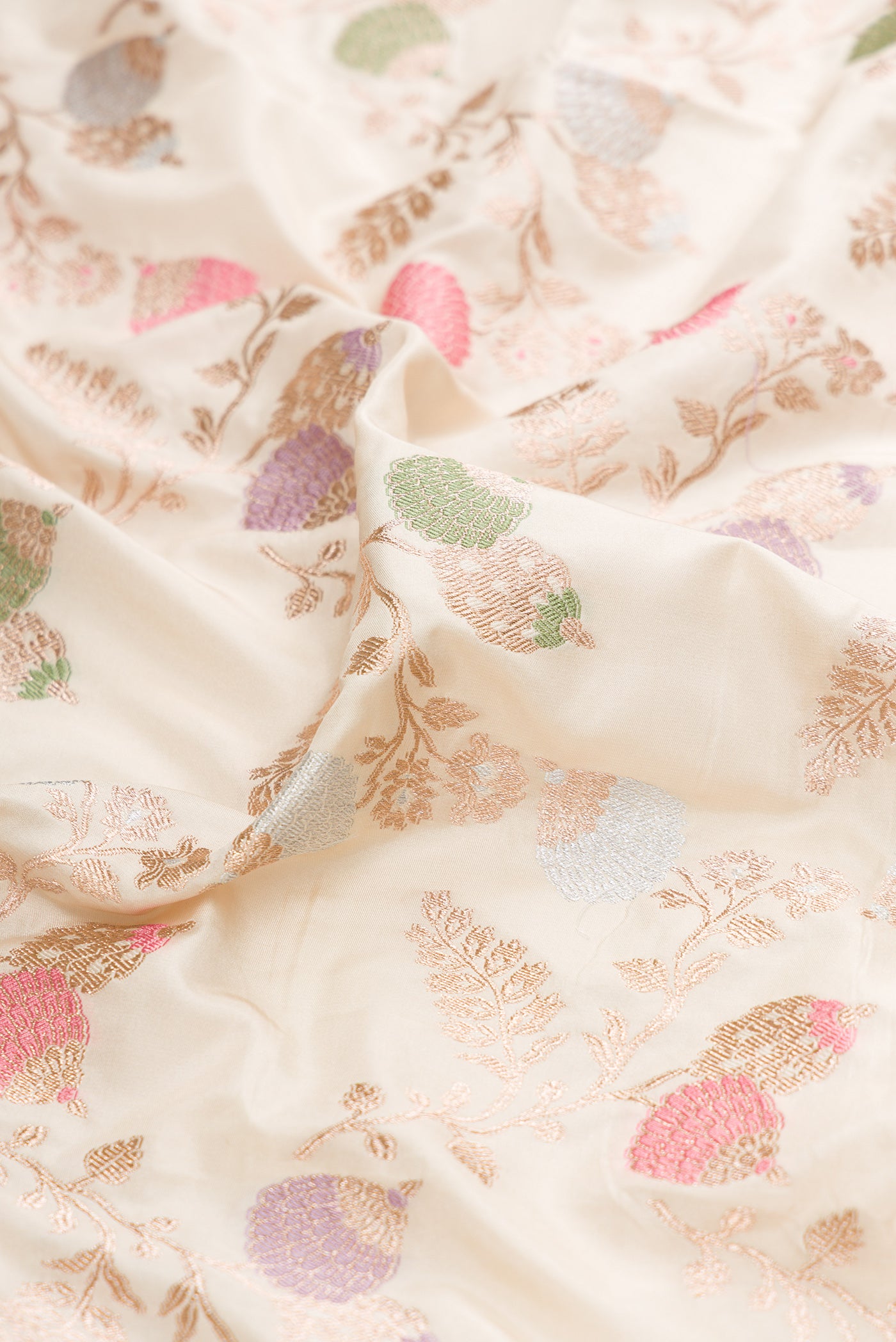 Close up of Cream Banarasi Silk Saree with Zari Brocade on the body and Zari Border.  displaying folds