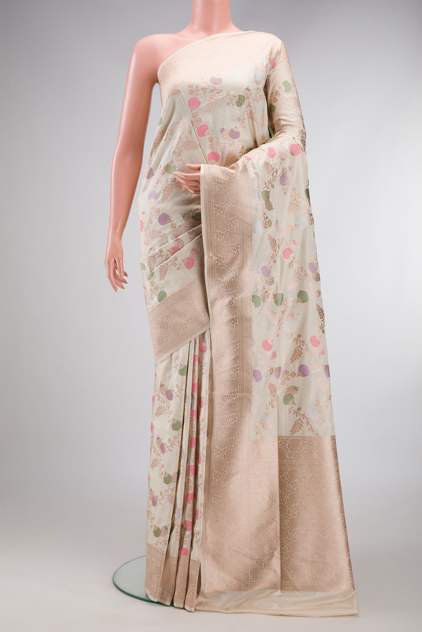 Cream Banarasi Silk Saree with Zari Brocade on the body and Zari Border.  displayed on a mannequin