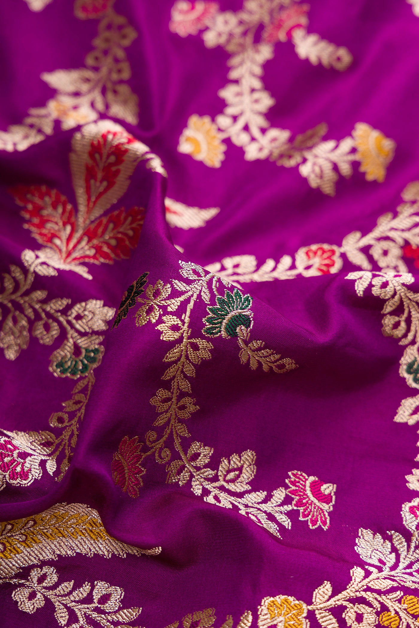 Close up of Purple Banarasi Silk Saree with Zari Brocade on the body and Fancy Border.  displaying folds