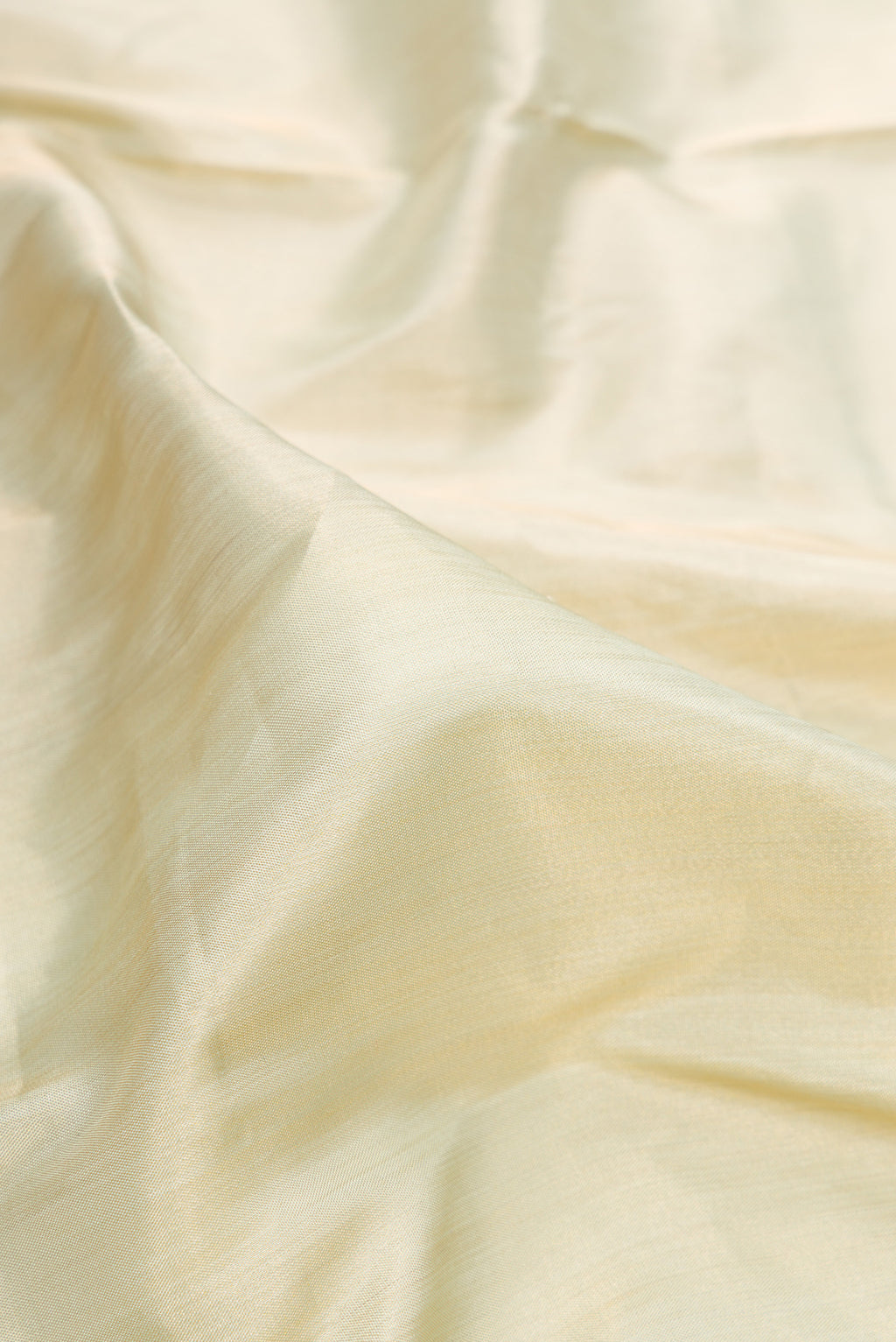 Close up of Pista Green Dual Tone Banarasi Tissue Saree with Plain Body and Fancy Border.  displaying folds