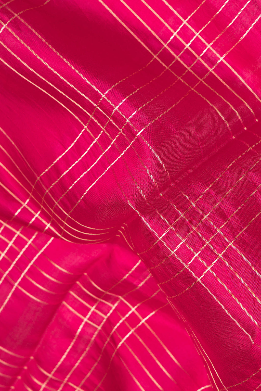 Close up of Pure Silk Dark Pink Dual Tone Tussar Saree with Checked design on the body and Fancy Border.  displaying folds
