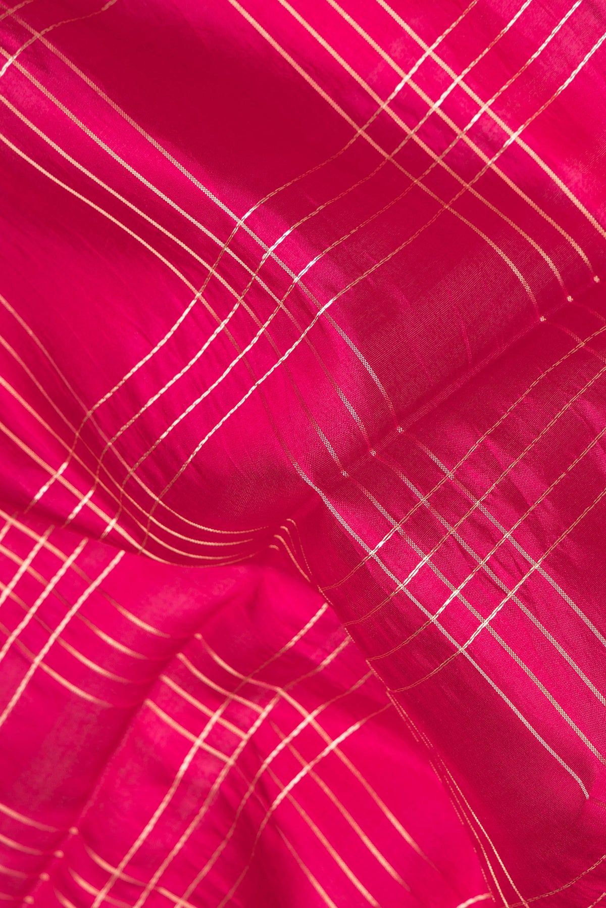 Close up of Pure Silk Dark Pink Dual Tone Tussar Saree with Checked design on the body and Fancy Border.  displaying folds