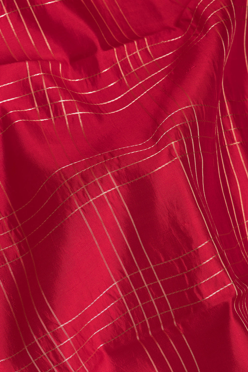 Close up of Red Tussar Silk Saree with Checked design on the body and Fancy Border.  displaying folds